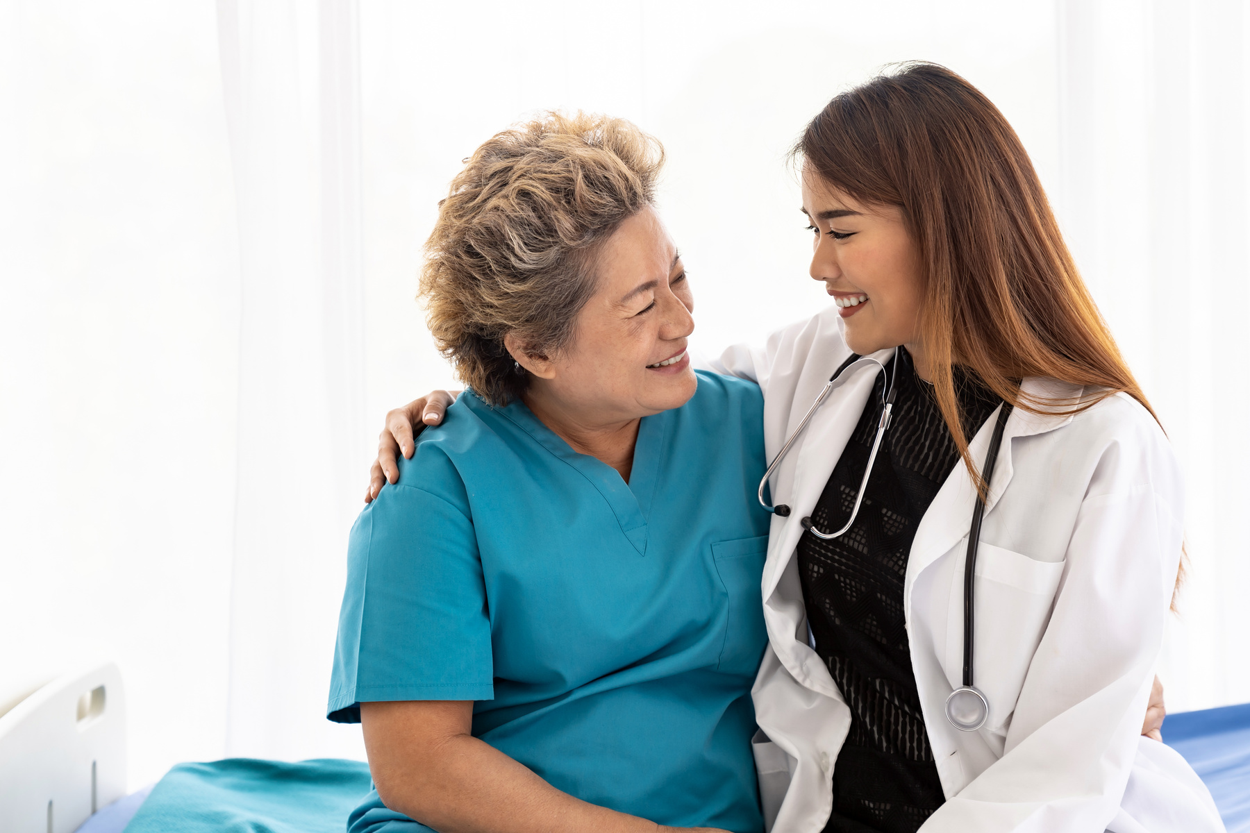 doctor hugging elderly patient